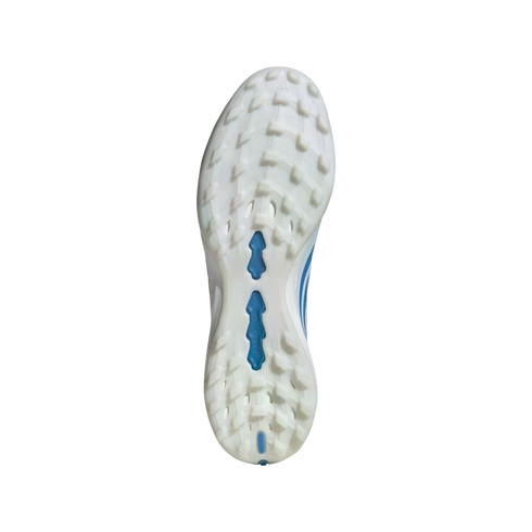 A bottom-up view of the white and light blue outsole of an Adidas Predator soccer shoe, featuring multi-directional studs against a black background.