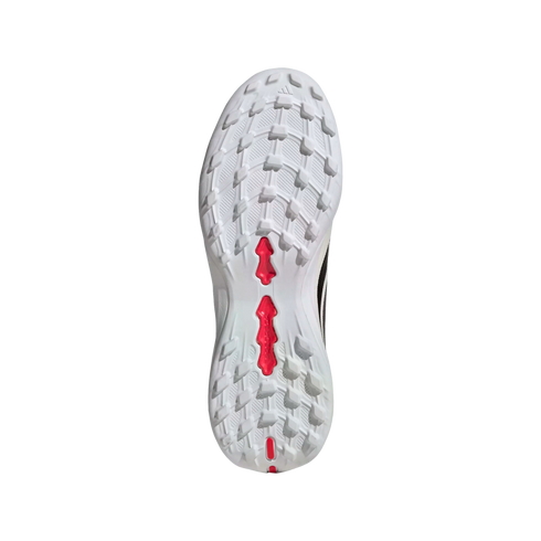 Textured white outsole of an athletic shoe with prominent red accents in the center and heel, shown against a plain black background.