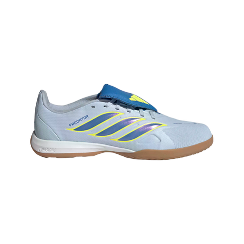 A side profile of a light blue Adidas Predator indoor soccer shoe featuring iridescent purple and yellow stripes, a blue fold-over tongue, and a gum-colored outsole against a black background.