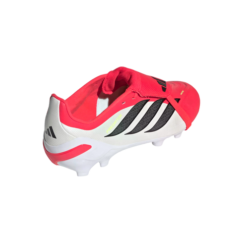 Rear side view of a red and white Adidas Predator soccer cleat with black stripes and a fold-over tongue, set against a black background.