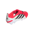 Rear side view of a red and white Adidas Predator soccer cleat with black stripes and a fold-over tongue, set against a black background.