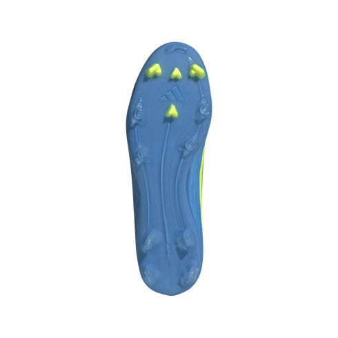A bottom-up view of the light blue sole of a soccer cleat, featuring four yellow studs at the toe and several translucent blue studs around the edges. The Adidas logo is embossed in the center of the front half. Long, curved ridges run the length of the s
