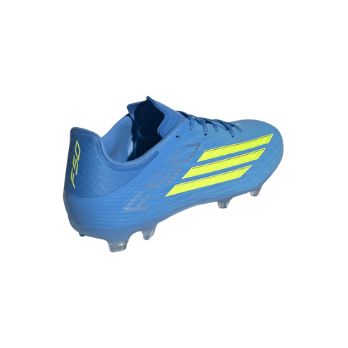 A bright blue Adidas F50 soccer cleat, shown from a rear three-quarter angle against a black background. The shoe features three neon yellow stripes on the side, the "F50" logo on the heel in the same color, and clear studs on the outsole.