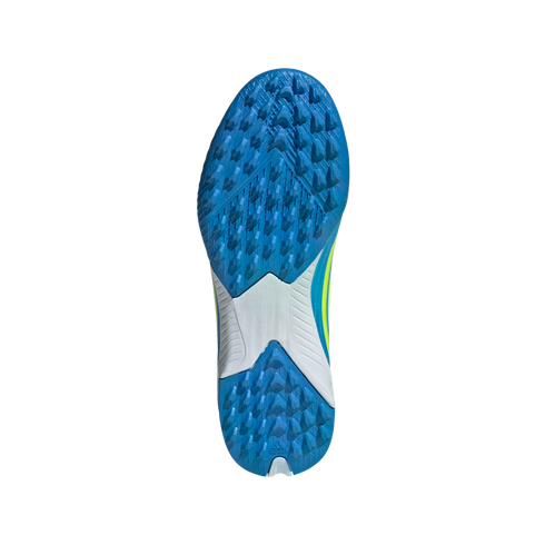 The blue and white textured outsole of an Adidas turf soccer shoe, featuring a dense pattern of small triangular cleats for traction and a white midfoot section.