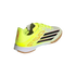 Neon yellow Adidas F50 indoor soccer shoe with black stripes, pink accents, white midsole, and gum rubber outsole on a black background.