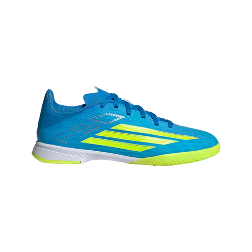 Profile view of a blue indoor soccer shoe featuring three slanted yellow stripes on the side, blue laces, a white midsole, and a lime green textured outsole.
