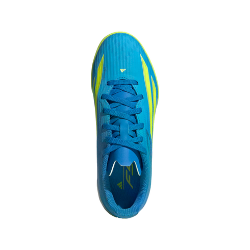 A top-down view of a bright blue Adidas F50 soccer shoe with lime green accents and blue laces, centered on a solid black background.