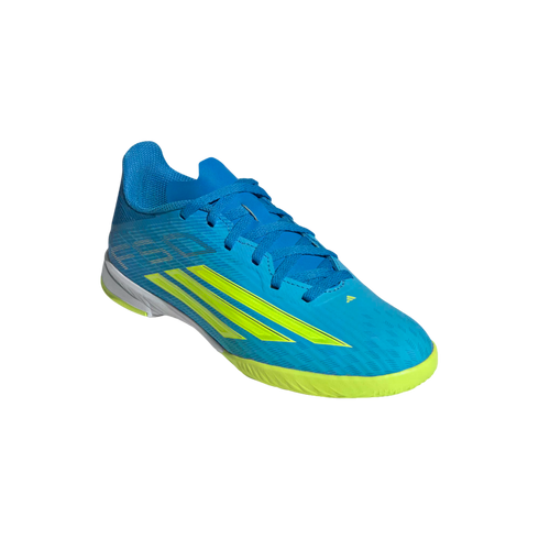 A bright blue and neon yellow Adidas indoor soccer shoe with a textured upper and three diagonal stripes on the side, set against a plain black background.