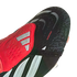 Close-up of a black and red Adidas Predator soccer cleat featuring a textured "NANOSTRIKE+" upper, red fold-over tongue with silver stripes, and a black "PREDATOR" strap.