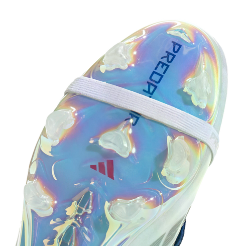 Close-up of the iridescent sole plate of an Adidas Predator soccer cleat, featuring clear studs and a white elastic strap.