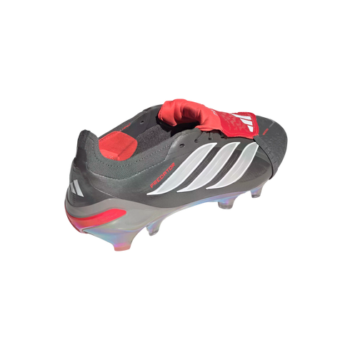 A dark grey and red Adidas Predator soccer cleat with white stripes and an iridescent sole, viewed from the rear side against a black background.