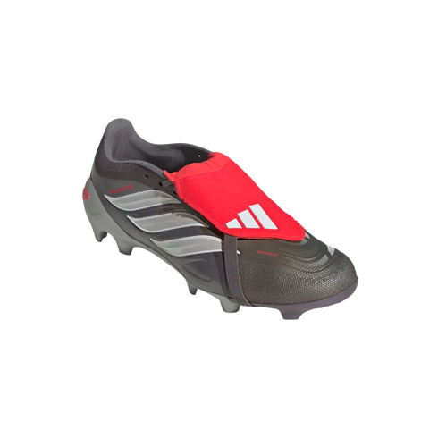 Grey and silver Adidas Predator soccer boot featuring a prominent red fold-over tongue with white logo, isolated on a black background.