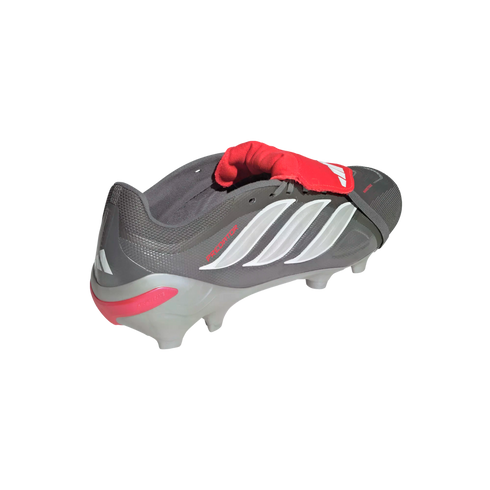 Grey Adidas Predator soccer cleat with white stripes and a red fold-over tongue on a black background.