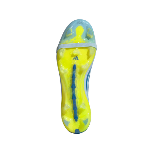 A studio shot from a top-down perspective of the bright yellow and translucent blue soleplate of an Adidas soccer cleat against a black background. The soleplate features various studs, a blue Adidas logo, a light grey band across the forefoot, and a blue