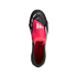Top-down view of a black Adidas Predator soccer cleat featuring a prominent pink fold-over tongue and white accents against a solid black background.