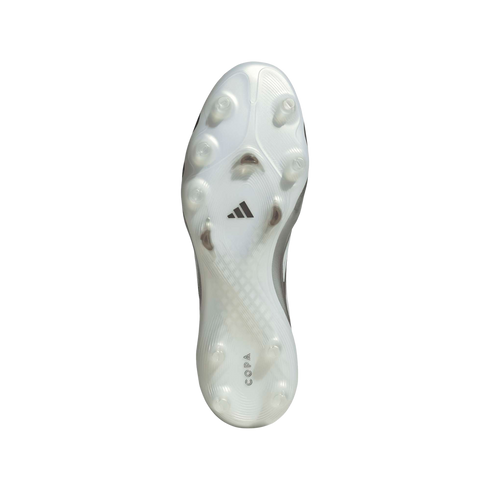 The white and translucent soleplate of an Adidas Copa soccer cleat against a black background, showing its traction studs, the Adidas logo in the center, and "COPA" branding at the heel.