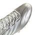 A close-up, angled view of a metallic silver Adidas soccer cleat against a solid black background. The cleat features white laces, three white stripes along the side, and a small black Adidas logo near the toe.