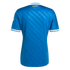 Back view of a blue soccer jersey with diagonal textured stripes, white sleeve cuffs, and gold "RMCF" lettering on the collar, set against a solid black background.