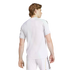 Rear view of a man with light brown hair wearing a white athletic t-shirt and white shorts with black stripes, isolated on a white background.