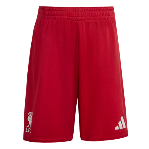 Red athletic shorts featuring a white Liverpool F.C. crest on the right leg and a white Adidas logo on the left leg, shown against a black background.