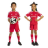 Two children wearing red Liverpool FC football kits. A boy holds a soccer ball while a girl smiles with her hands on her hips.