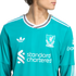 A person wearing a teal Liverpool FC long-sleeve jersey featuring white Adidas, Standard Chartered, and Expedia logos against a white background.