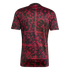 Back of a black short-sleeved jersey featuring a complex red ornate scrollwork pattern arranged in a grid across the entire fabric.