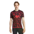 A man wearing a black and red patterned Adidas Liverpool F.C. training jersey with AXA sponsor logo, against a black background.