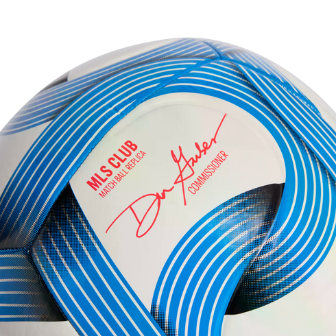 Close-up of an MLS soccer ball replica with blue curved graphics and a red signature from Commissioner Don Garber.