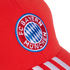Close-up of a red baseball cap featuring the embroidered FC Bayern Munich circular crest and white stripes on the brim.