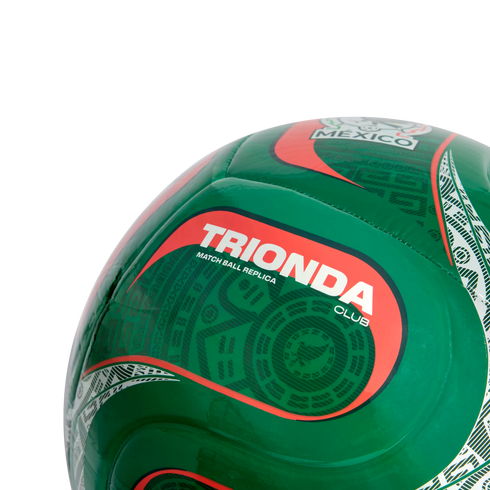 Close-up of a green soccer ball with Mexico-themed Aztec patterns and a red-bordered section labeled "TRIONDA CLUB MATCH BALL REPLICA".
