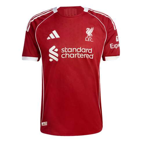 Red Liverpool F.C. home jersey by Adidas featuring the white club crest, Standard Chartered center sponsor, and Expedia sleeve sponsor.