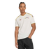 A man in a white Adidas Venezuela jersey with colorful shoulder stripes and gold trim, posed against a black background.