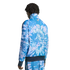 A person from behind wearing a blue and purple tie-dye tracksuit with a small circular logo on the jacket back. Solid black background.