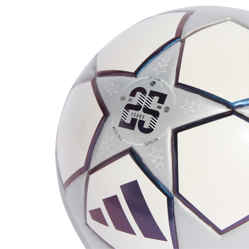 Close-up of an Adidas UEFA Champions League soccer ball with a "25 YEARS" anniversary star panel and iridescent details on a black background.