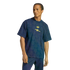 A man modeling a navy blue Adidas x Arsenal t-shirt with a geometric pattern and yellow logos, paired with navy track pants against a black background.