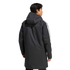 Rear view of a man in a long black hooded parka with white stripes on the sleeves, against a light gray background.