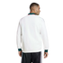 Rear view of a man in a white track jacket with green cuffs and a 'MÉXICO' collar, paired with black track pants against a black background.