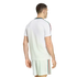 Rear view of a man wearing a white athletic t-shirt and matching shorts set, featuring green, red, and white stripes down the sleeves and sides, set against a black background.
