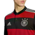 Close-up of a person wearing a red and black striped Germany football jersey featuring the Adidas logo and the DFB crest with three stars.