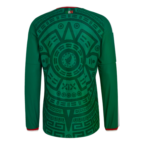 Back view of a green Mexico soccer jersey featuring a detailed dark green Aztec-inspired pattern on the back and red and white trim on the cuffs.