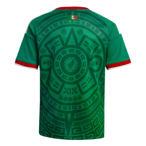 Back view of a green soccer jersey featuring an intricate dark green Aztec-inspired pattern, with red and white trim on the collar and sleeves.