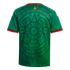 Back view of a green soccer jersey featuring an intricate dark green Aztec-inspired pattern, with red and white trim on the collar and sleeves.