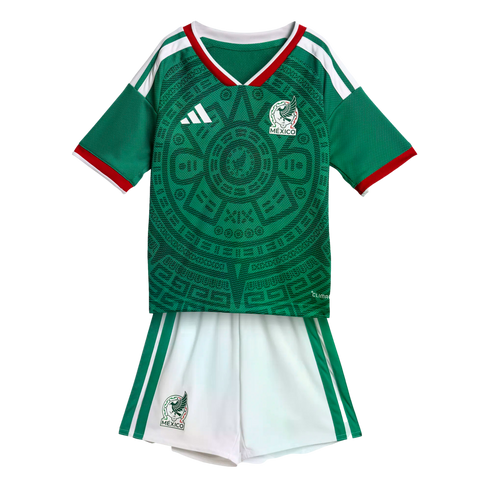 Mexico national football team kit with a green Aztec-patterned jersey and white shorts on a black background.