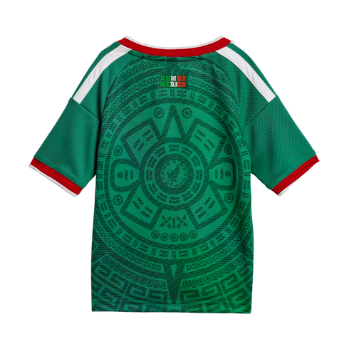 Green soccer jersey back with a large Aztec sun stone pattern, red and white trim, and white shoulder stripes.
