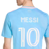 Back of a light blue soccer jersey with "MESSI" and "10" in white. It features pink trim and the words "FREEDOM TO DREAM" printed on the upper back.