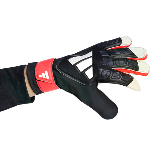 Hand wearing a black, red, and white Adidas goalkeeper glove with a textured grip, positioned against a solid black background.