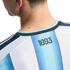 Close-up from behind of a person wearing a light blue and white striped jersey with the number "1893" printed just below the collar.