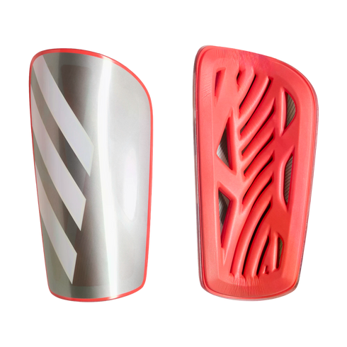 Two shin guards: one silver with white stripes and red trim, the other showing a red foam backing with an intricate ventilation pattern.
