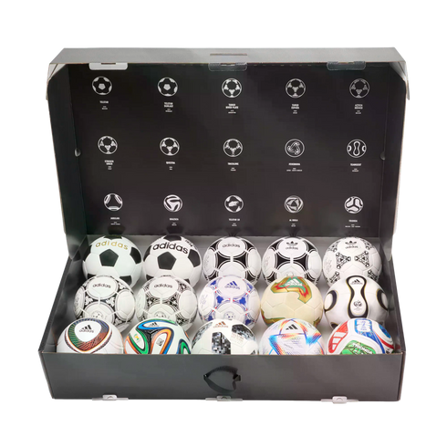 A display box containing 15 miniature Adidas World Cup soccer balls, with historical ball design illustrations on the inner lid.